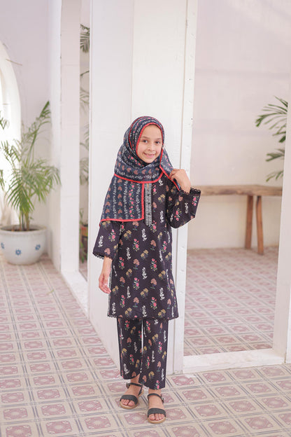 Child wearing a dark floral outfit with a matching hijab in a room with plants and a table.