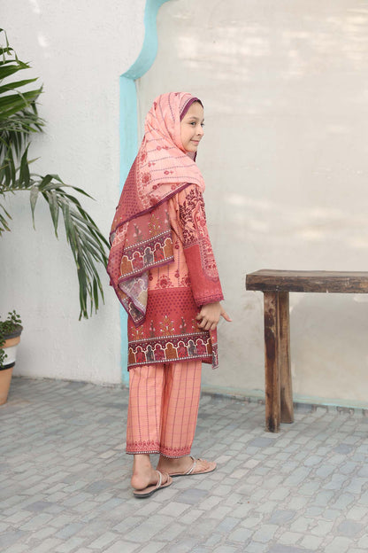Woman wearing a traditional outfit with a pink hijab and red and pink patterned dress in an indoor setting.