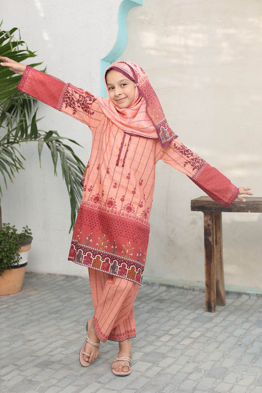 Child wearing a pink traditional outfit with floral patterns indoors.