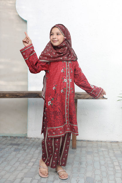 Girl in a red traditional outfit with floral patterns standing on a bench.