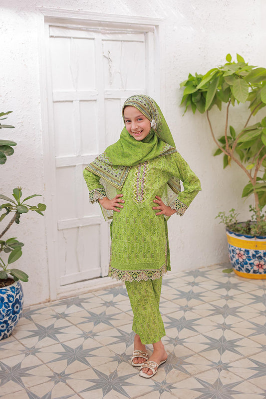 A girl wearing a mint green festive embroidered outfit with a long-sleeved shirt, trousers, and a dupatta, standing in an outdoor setting with potted plants in the background.