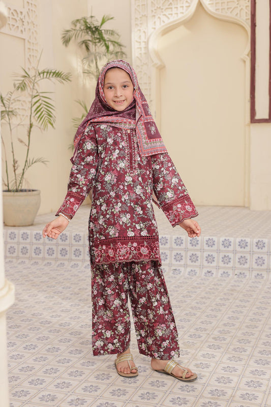 Child wearing a floral outfit with a matching headscarf in a decorated room.