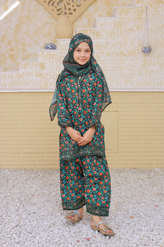 Child wearing a floral outfit standing on a textured surface with a beige wall in the background