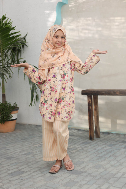 Woman wearing a floral outfit with a hijab in an outdoor setting