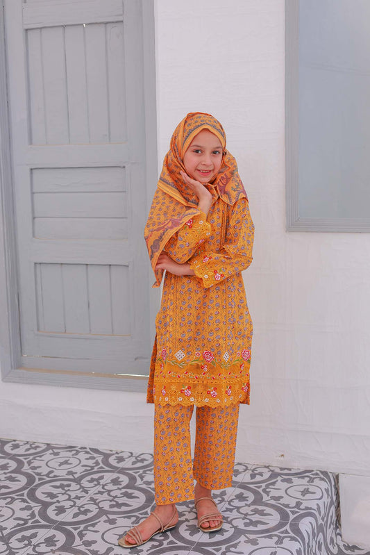 A girl wearing a festive embroidered golden shirt with chikankari and laser cutwork, paired with matching trousers and a dupatta, standing against a white background.