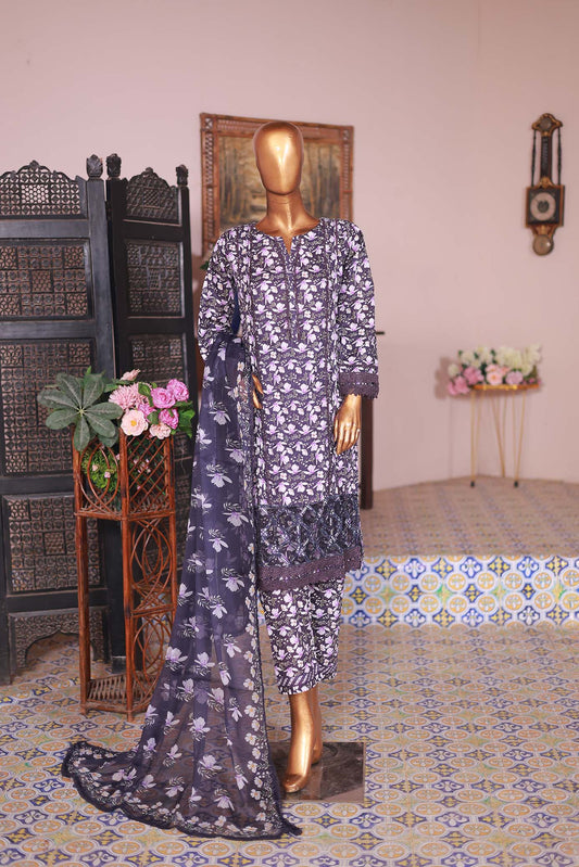 A mannequin displaying a woman's clothing set, consisting of a long-sleeved shirt with embroidery, a printed trouser, and a printed dupatta, arranged in a room with decorative background.