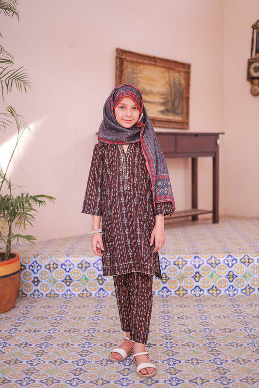 A girl wearing a black printed shirt with embellishments, a matching dupatta, and printed trousers.