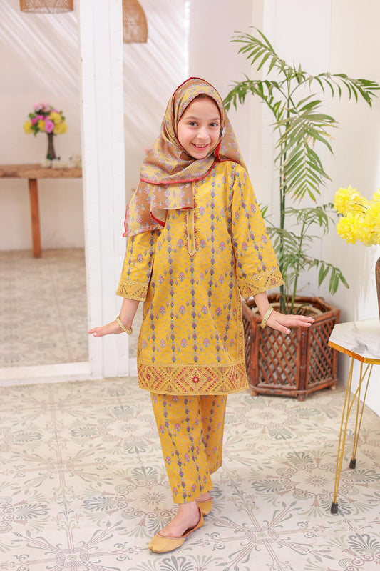 A girl wearing a traditional yellow outfit with embroidered details and a dupatta.