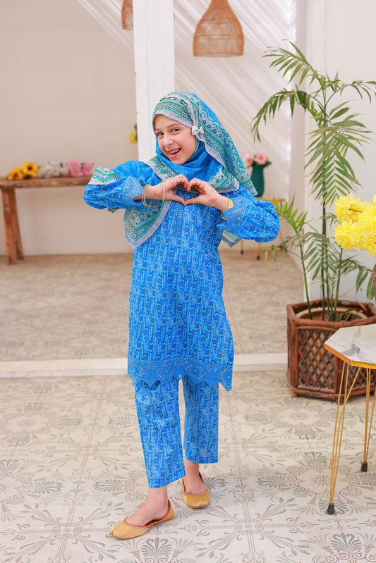 A woman posing in a blue printed shirt with embroidery and lacework, along with matching printed trousers and a dupatta.